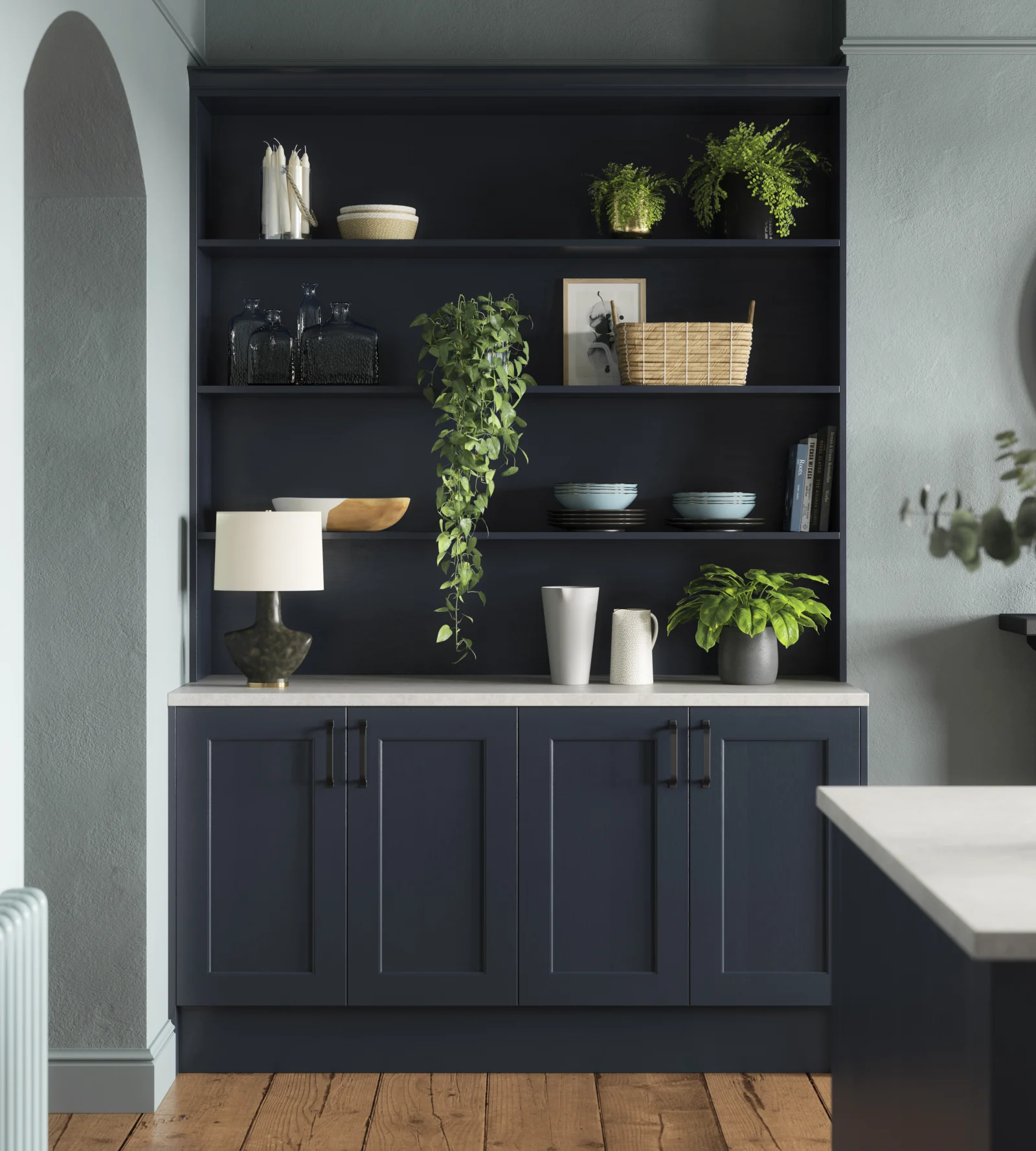 A modern kitchen featuring blue cabinets and a sleek white countertop, creating a stylish and inviting atmosphere.