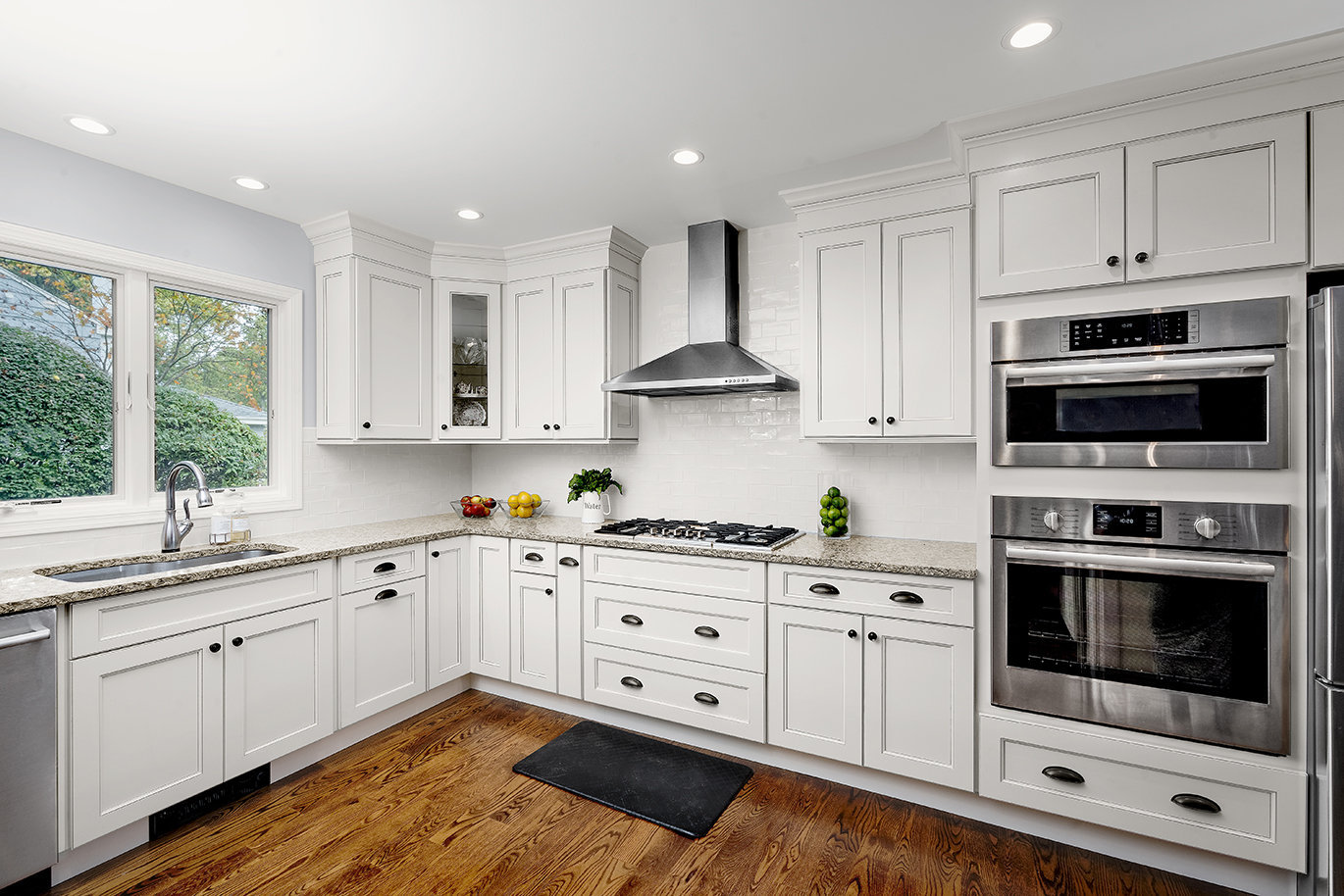 A modern kitchen featuring sleek white cabinets and polished stainless steel appliances, creating a bright and airy atmosphere.