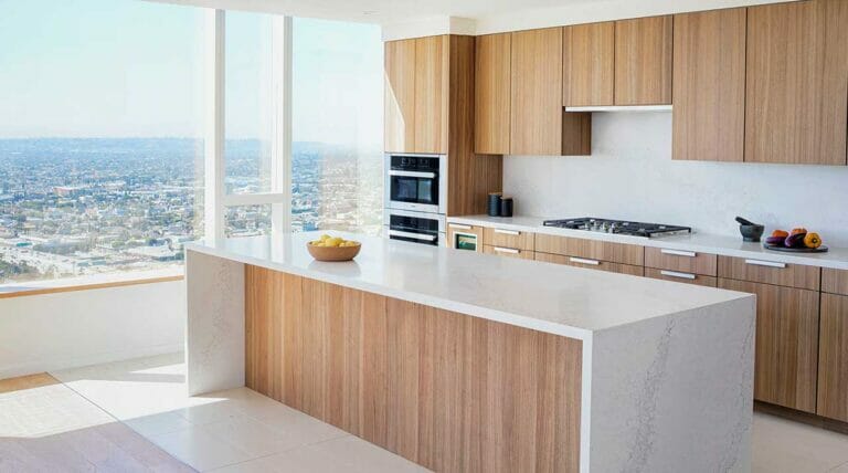 A sleek modern kitchen featuring large windows that showcase a stunning view of the city skyline.