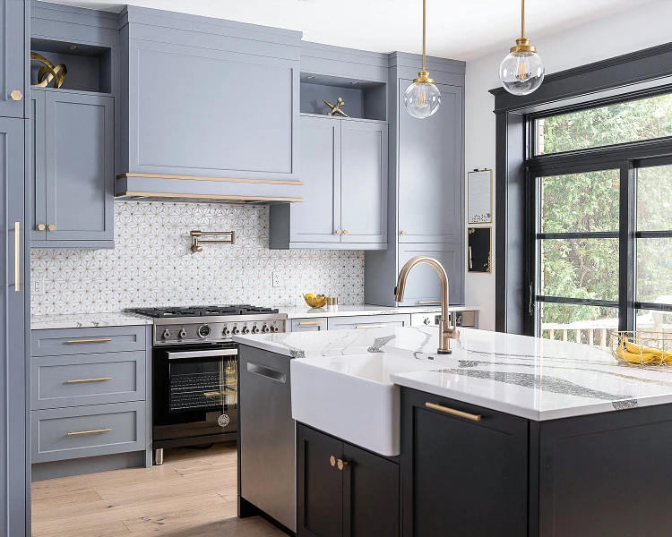 A modern kitchen featuring blue cabinets and sleek black countertops, creating a stylish and contemporary atmosphere.