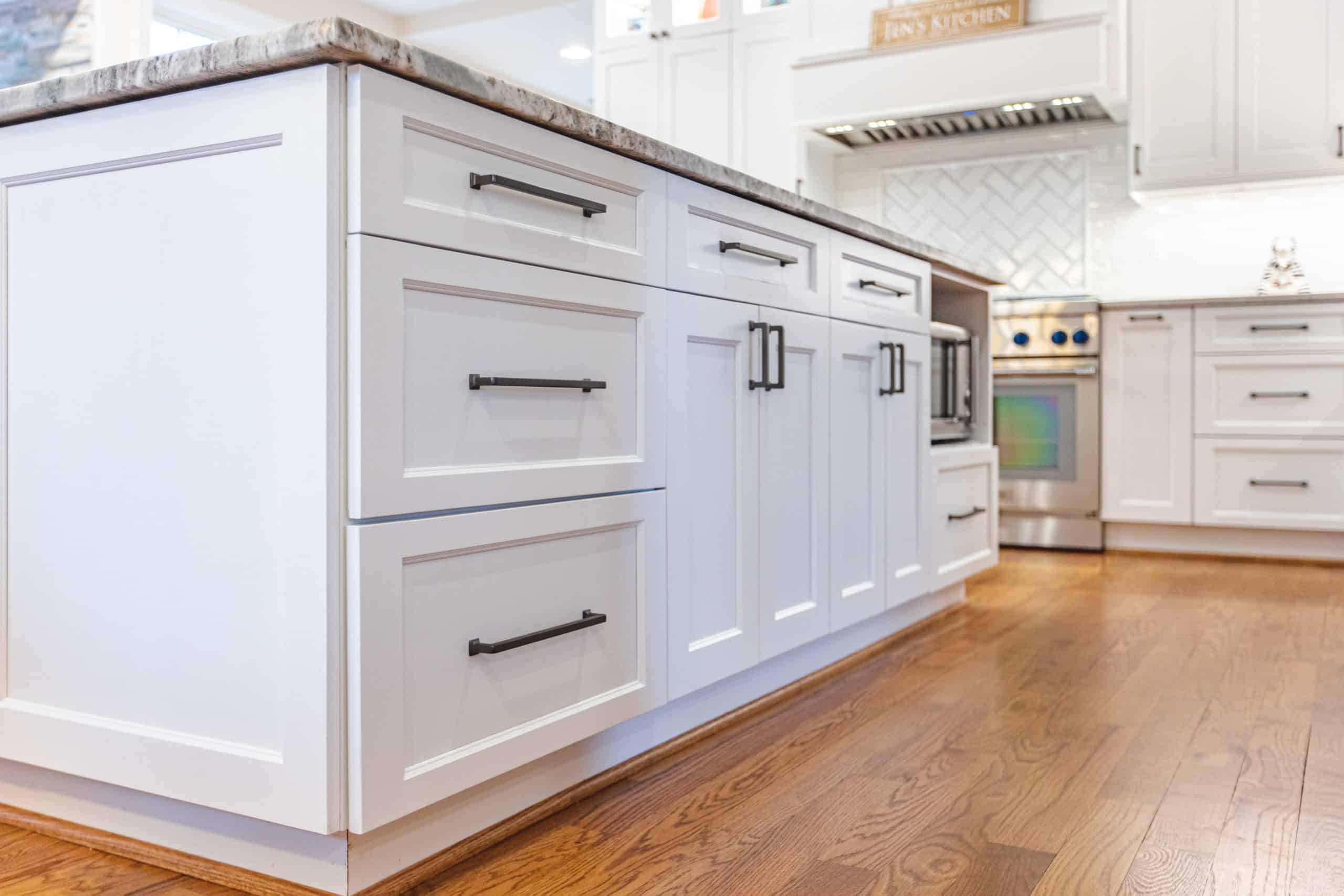 A stylish kitchen showcasing pristine white cabinetry paired with luxurious marble countertops, enhancing the overall design