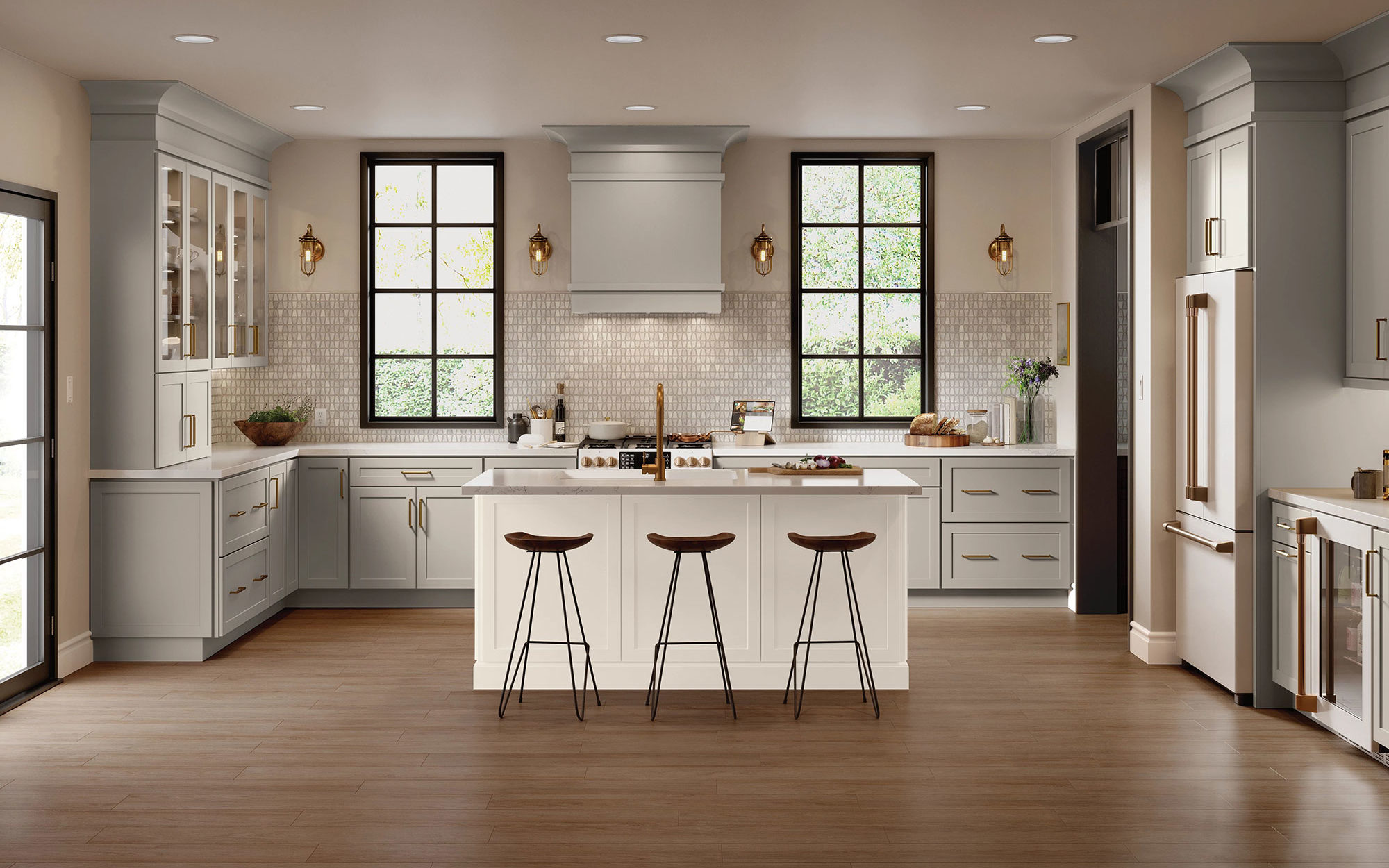 A modern kitchen featuring white cabinets and warm wood floors, creating a bright and inviting atmosphere.