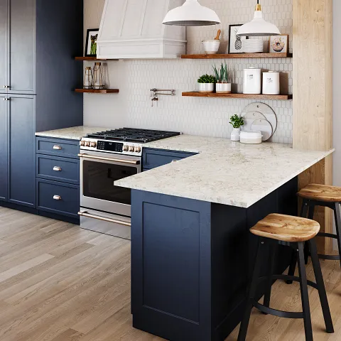 A modern kitchen featuring blue cabinets and elegant white countertops, creating a fresh and inviting atmosphere.