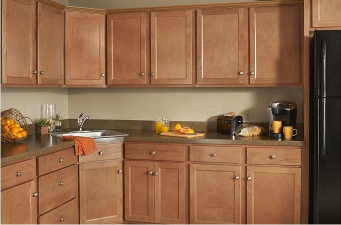 A modern kitchen featuring wooden cabinets complemented by sleek black appliances, creating a stylish and functional space.