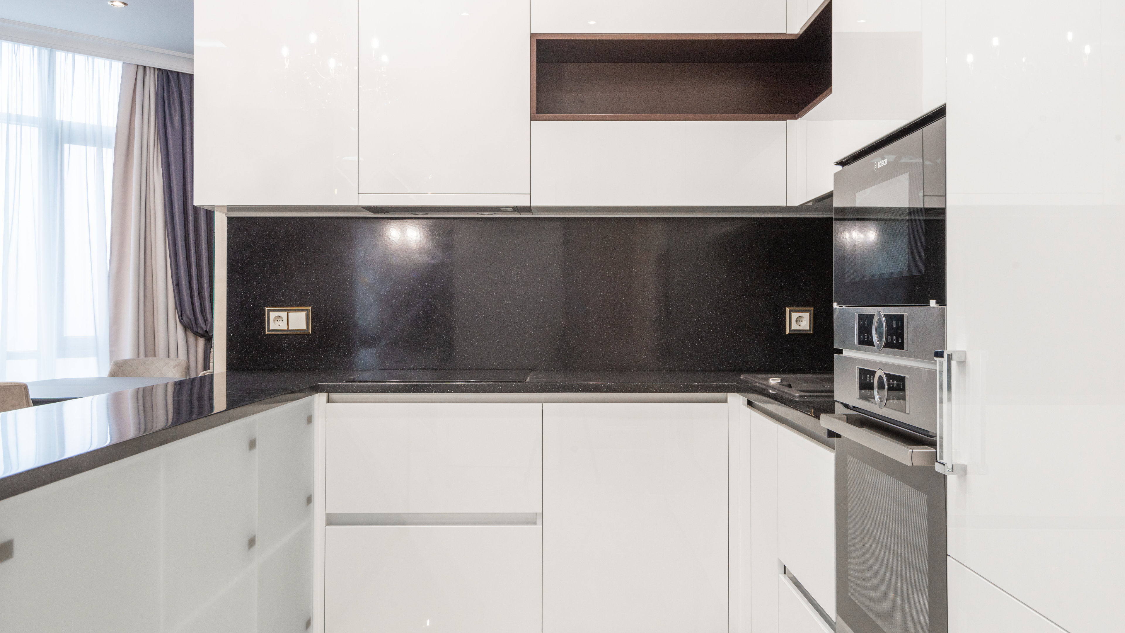 Bright and airy kitchen with white cabinetry, a large island, and contemporary appliances, perfect for cooking and entertaining.