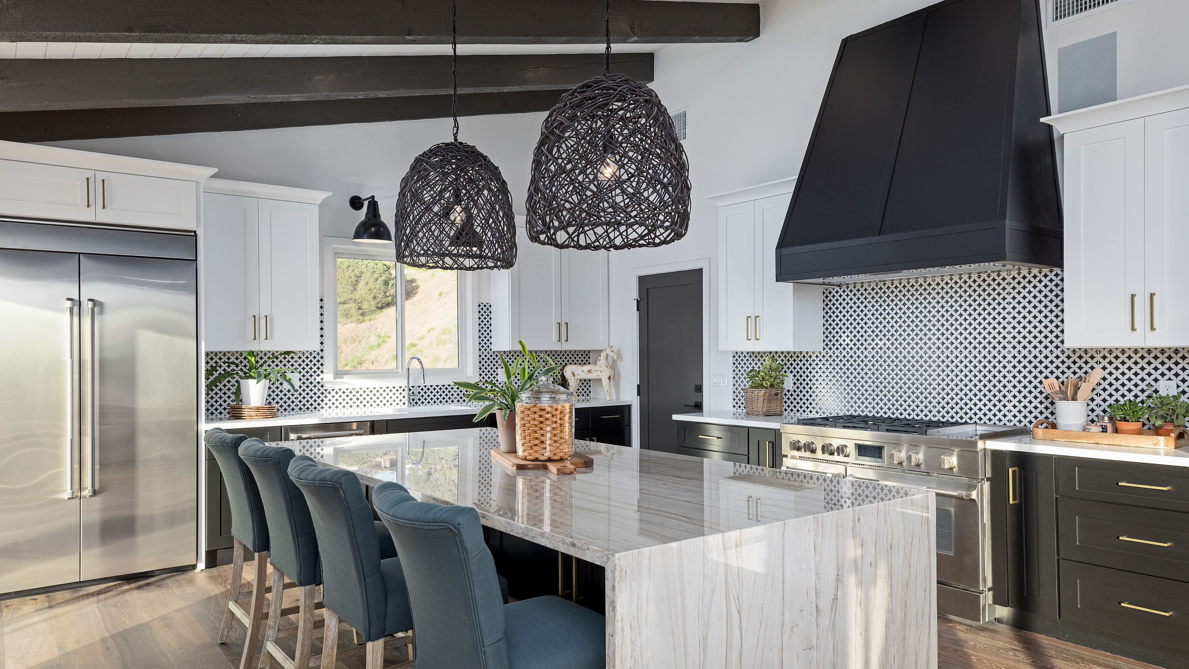 A modern kitchen featuring sleek white cabinets paired with elegant black countertops, creating a stylish contrast.