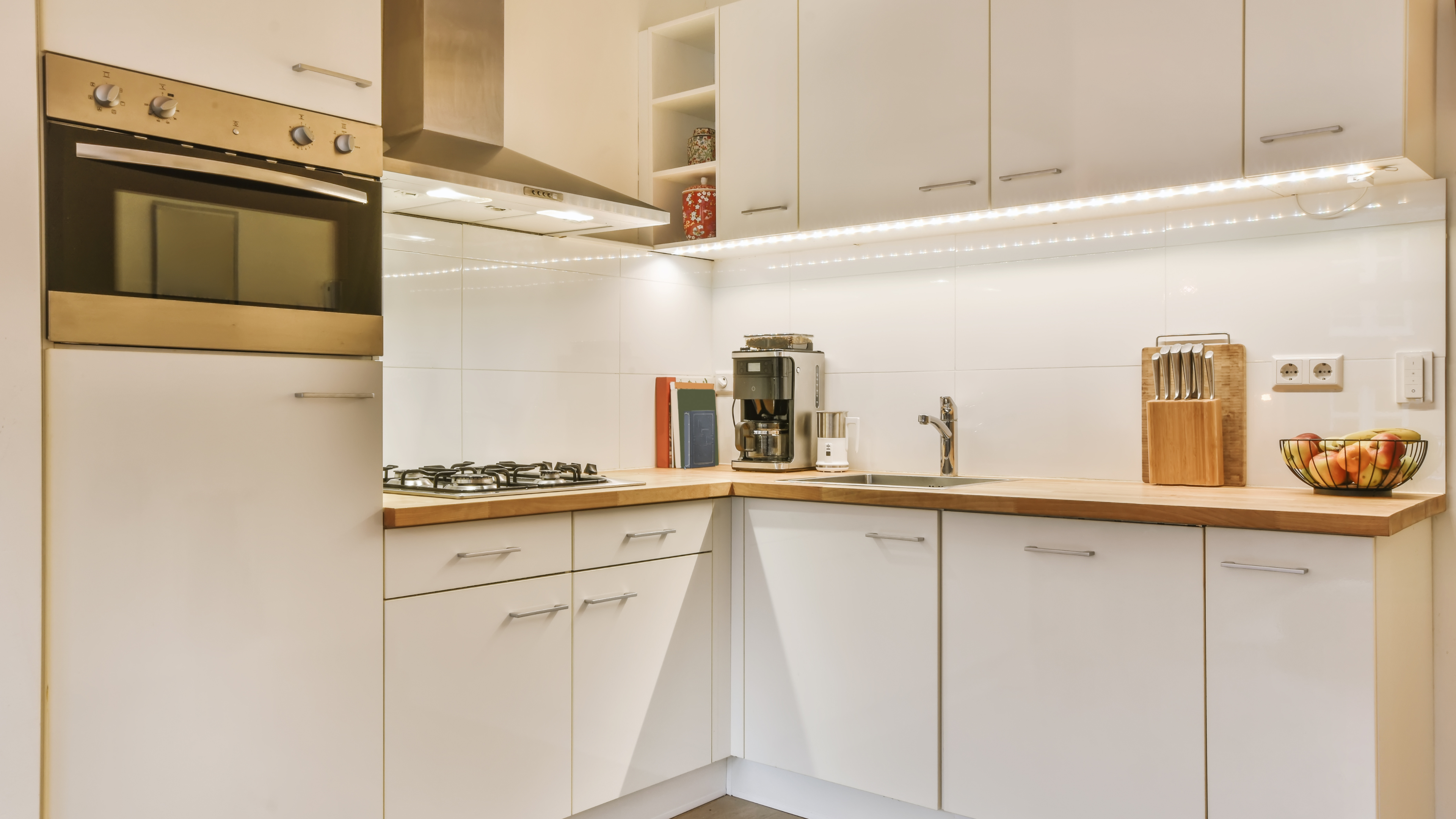 A bright kitchen adorned with white cabinetry and a contemporary microwave, emphasizing a fresh and inviting atmosphere.