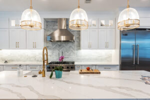 A bright kitchen adorned with white cabinets and a stove