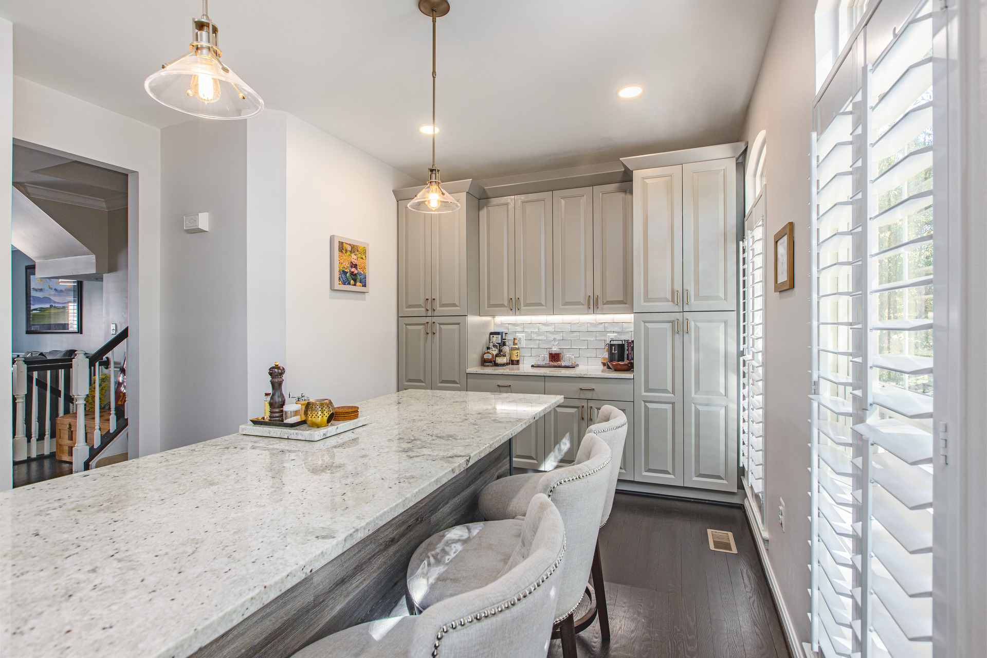 A beautifully designed kitchen with striking blue cabinets and a refined marble island, offering a fresh and modern aesthetic.