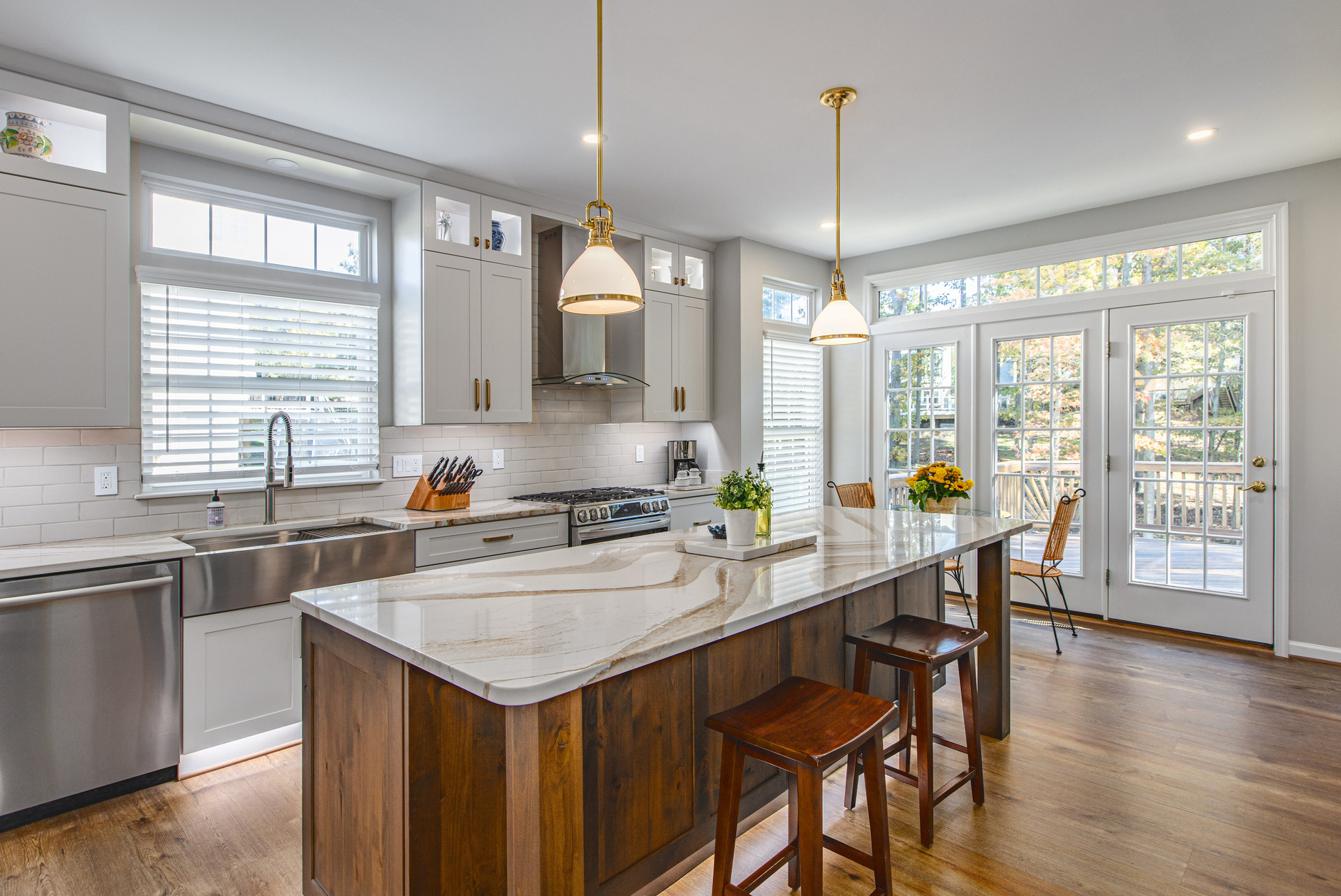 A spacious kitchen featuring a large island and elegant wooden flooring, creating a warm and inviting atmosphere.