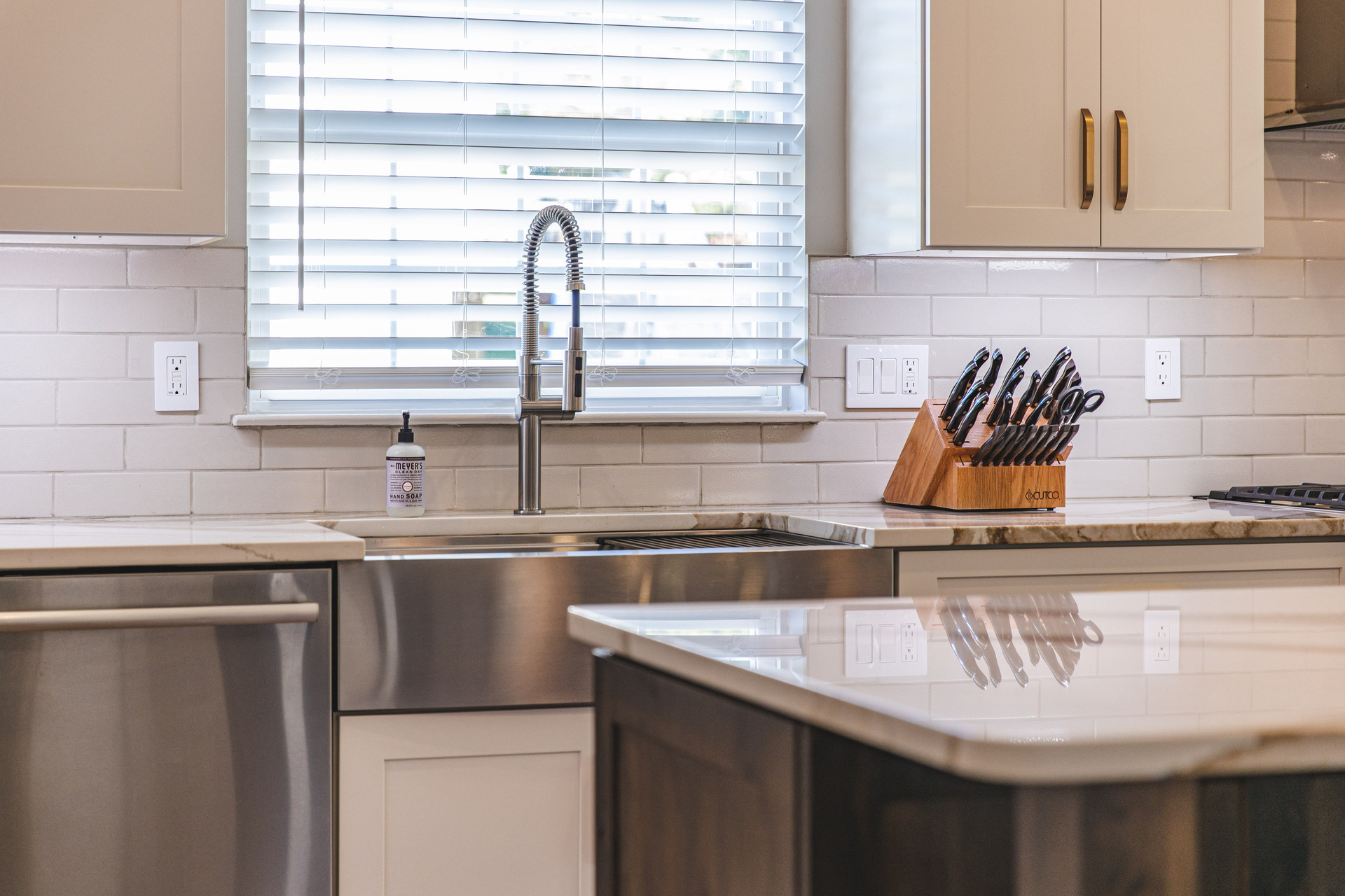 A modern kitchen featuring a sink and a stove, showcasing a clean and functional design