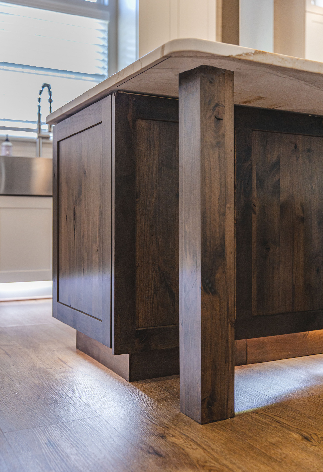 A contemporary kitchen equipped with a stainless steel oven and a rustic wooden island, emphasizing functional elegance.