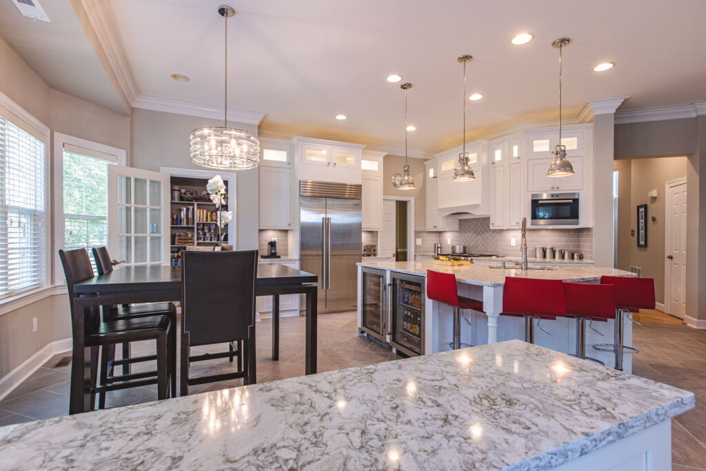 A modern kitchen featuring a central island and a cozy dining area