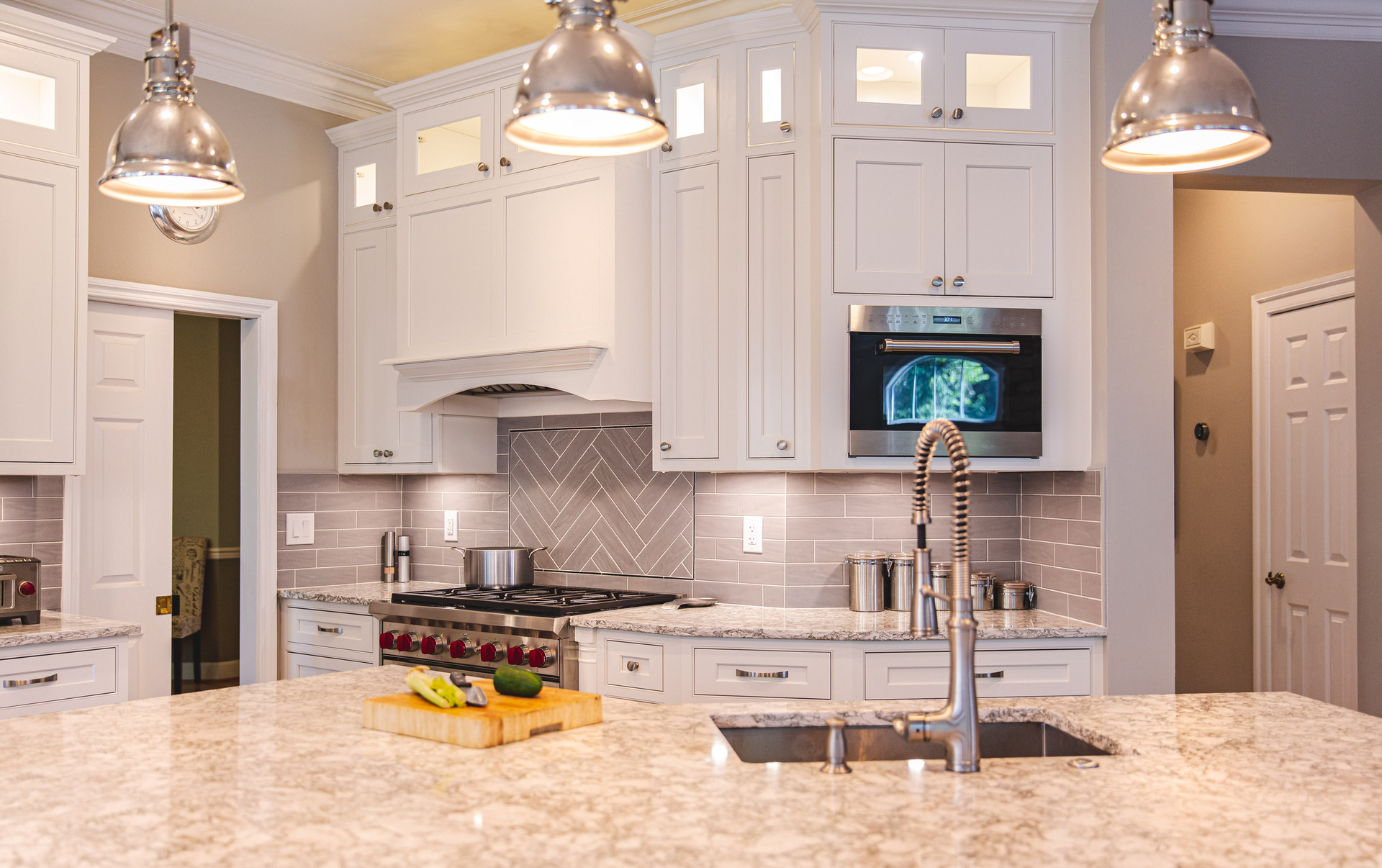 bright kitchen scene displaying a sink, stove, and refrigerator, emphasizing a contemporary and efficient layout.