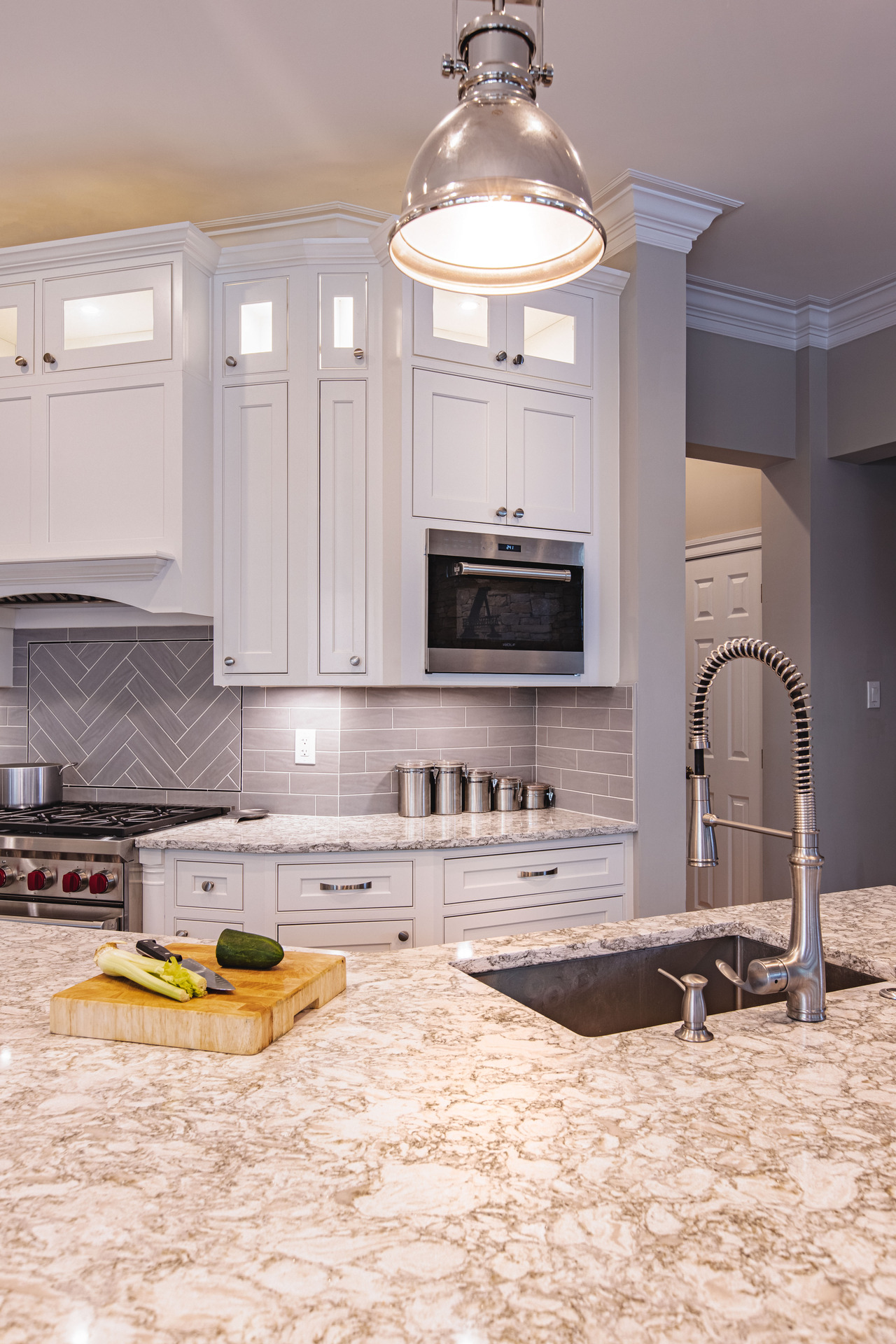 A contemporary kitchen setup including a sink, stove, and refrigerator, designed for efficiency and convenience.