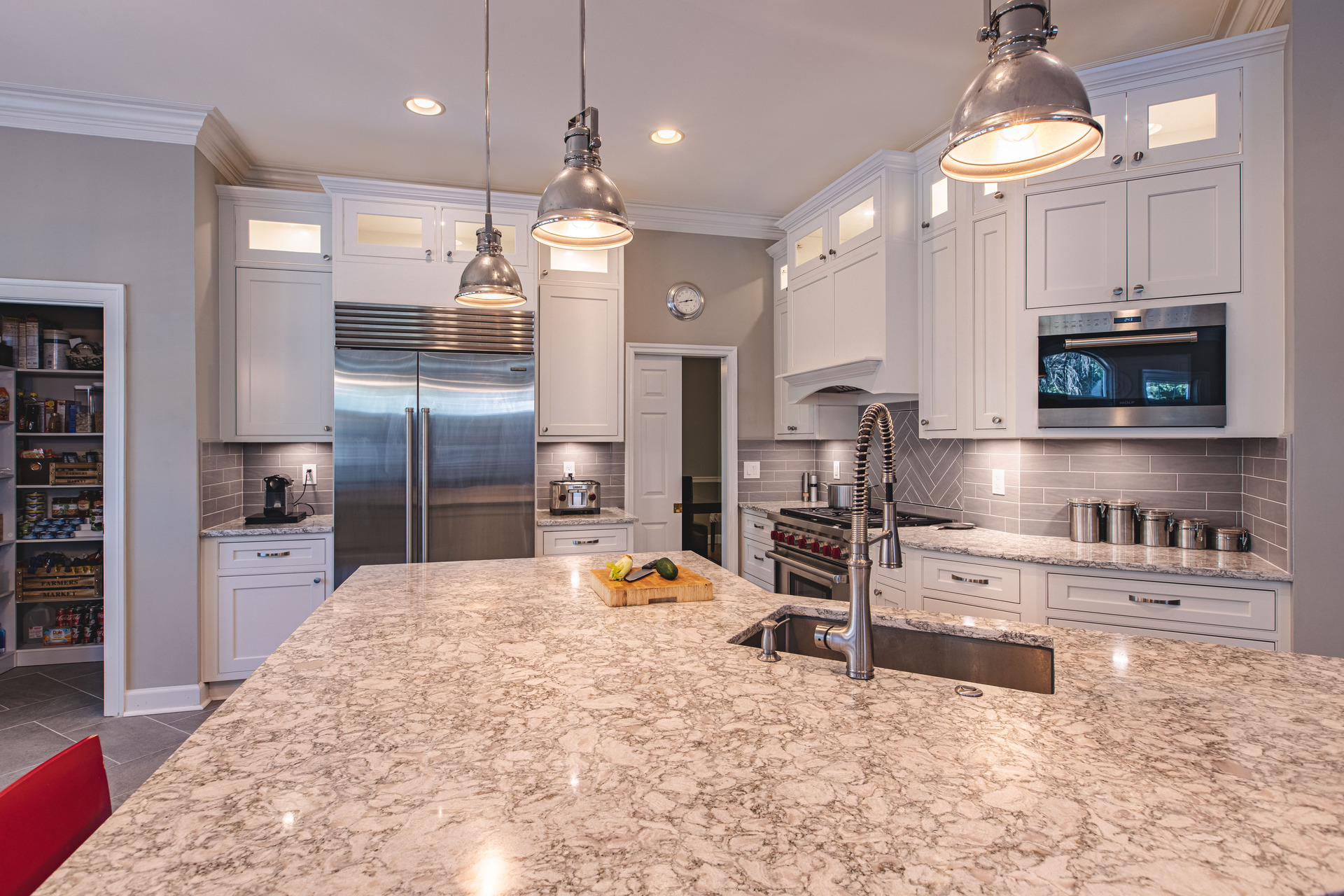 A modern kitchen featuring a sink, stove, and refrigerator, showcasing a clean and functional design.