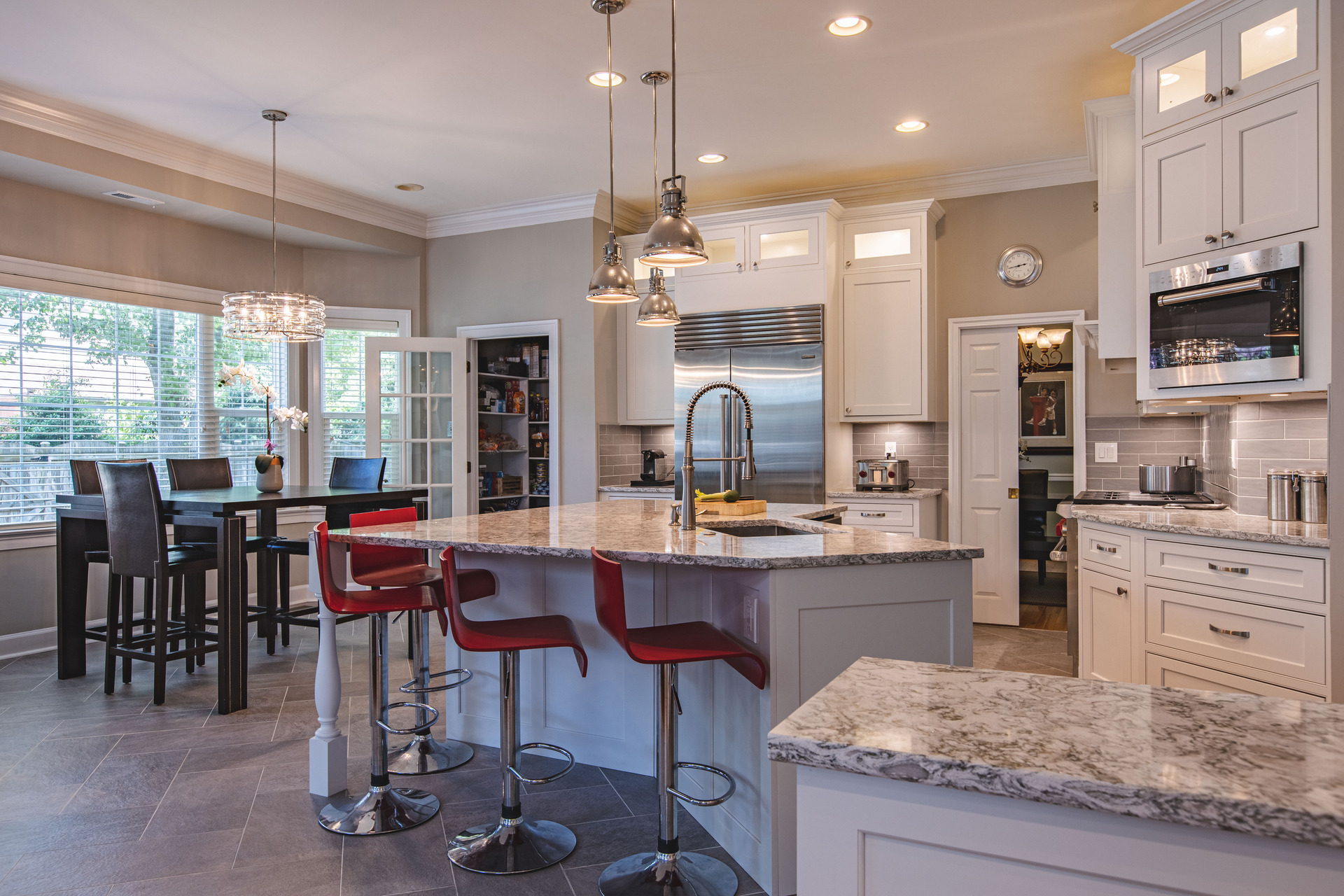 A well-lit kitchen showcasing a table with chairs, perfect for family meals and gatherings