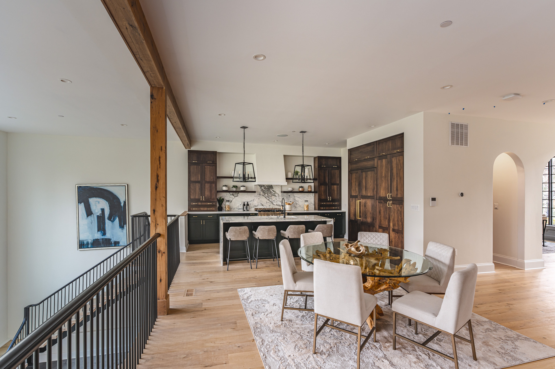 A contemporary kitchen adorned with warm wooden cabinets and polished marble countertops, creating an inviting atmosphere.