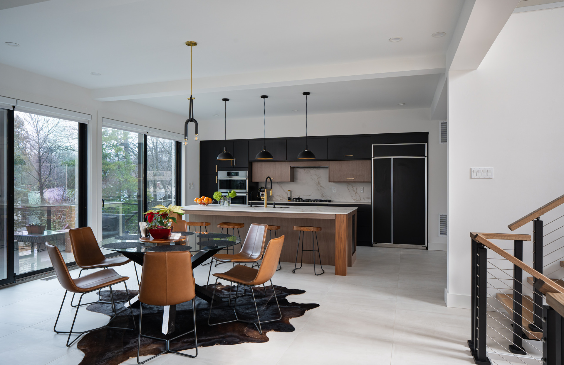 A stylish modern living room showcasing a fireplace and large windows that enhance the room's brightness and warmth.