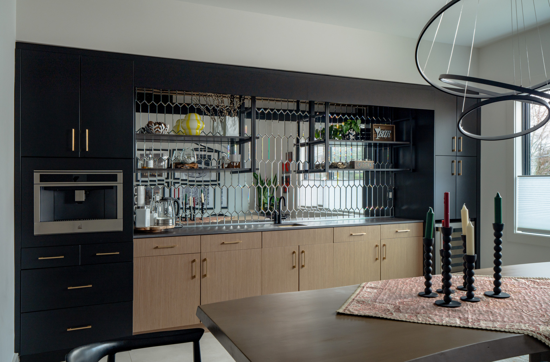 A refined kitchen space highlighting black cabinets and a polished marble island, creating a modern aesthetic.