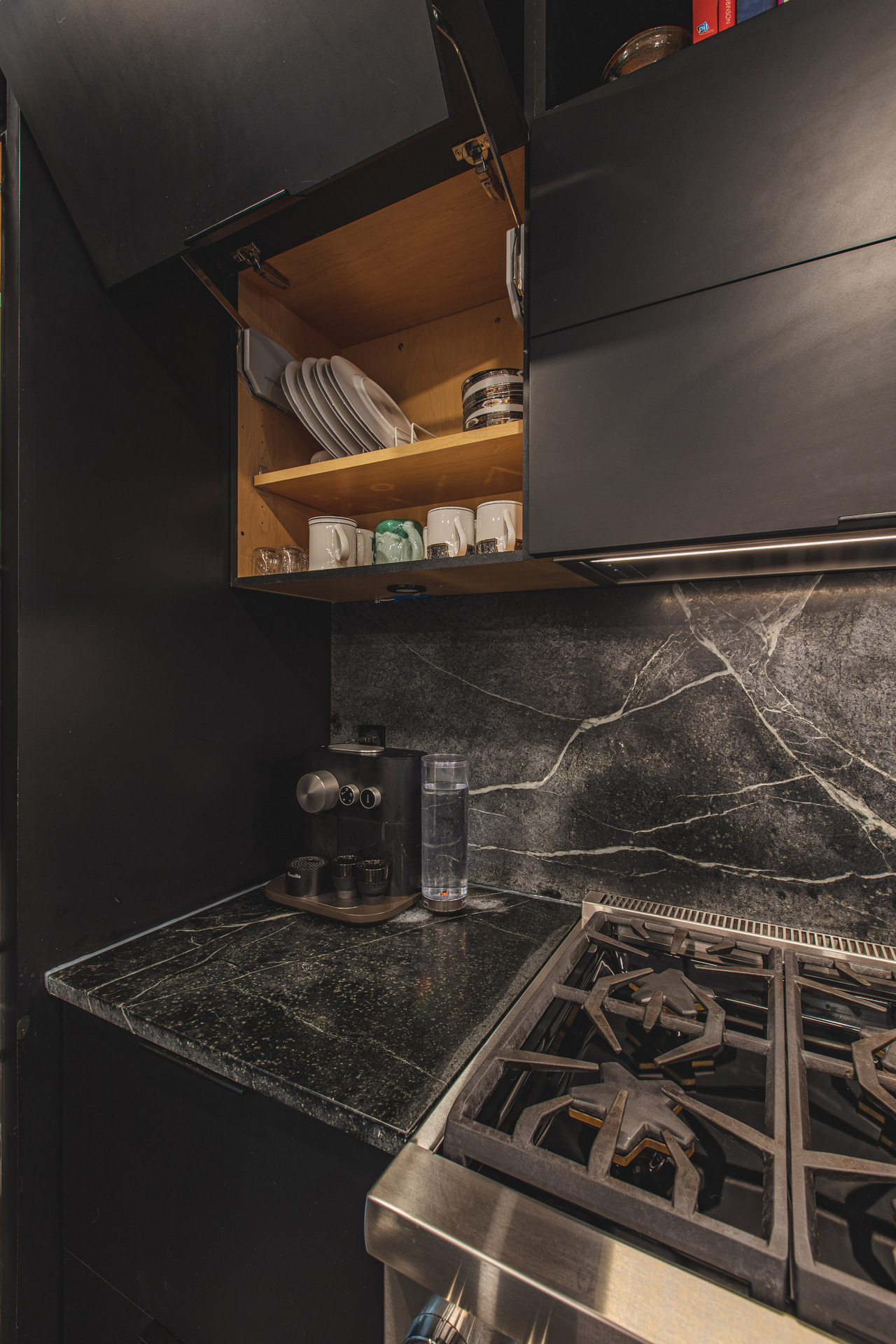 A modern kitchen featuring a stove and a sink, showcasing a clean