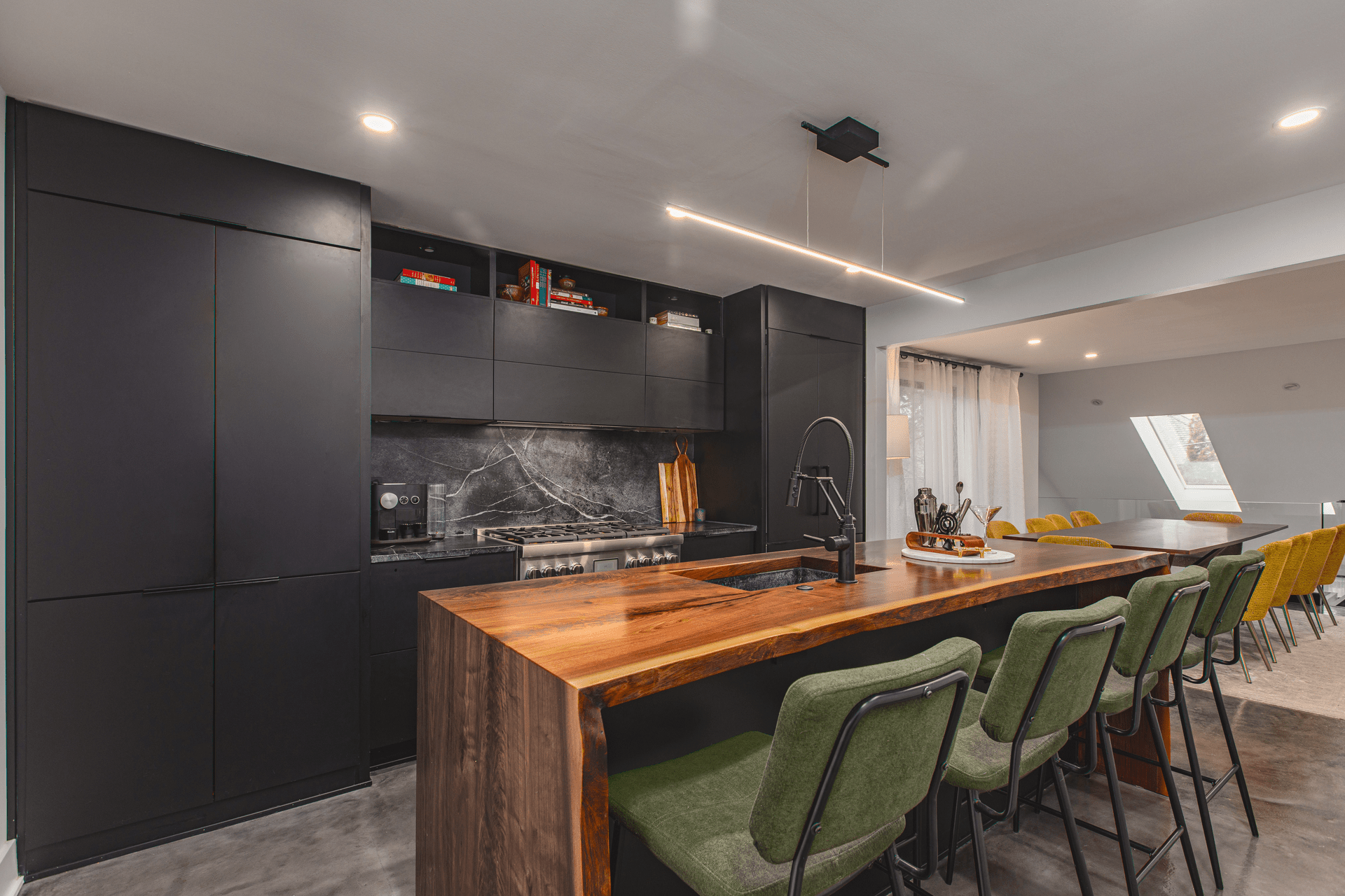 A modern kitchen featuring a sleek counter and a stylish bar area