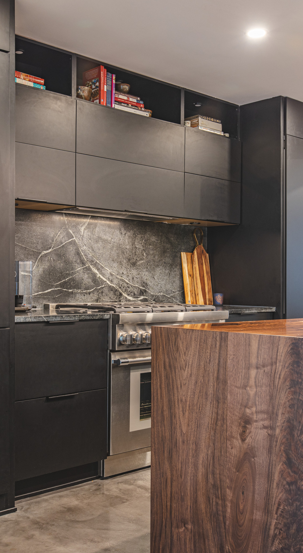 A spacious kitchen featuring a large island at the center and a modern stove