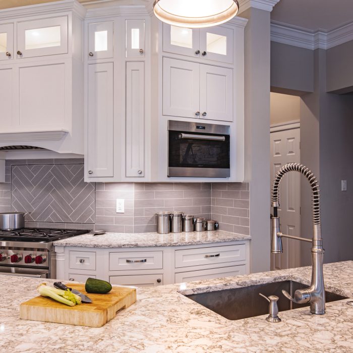 USA C Rockville-6 A contemporary kitchen setup including a sink, stove, and refrigerator, designed for efficiency and convenience.