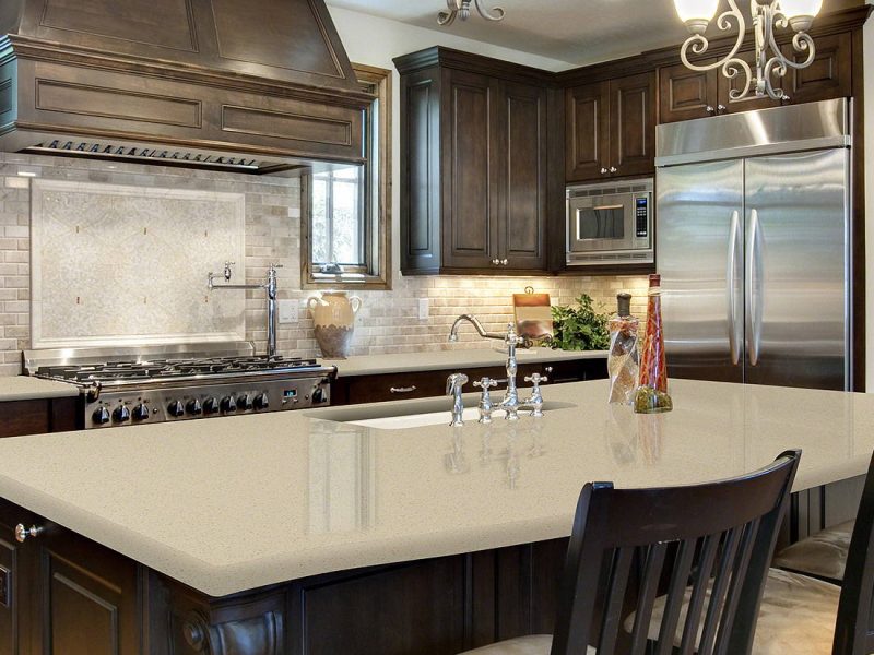 A spacious kitchen featuring a large island and a modern stove, showcasing a stylish and functional design.